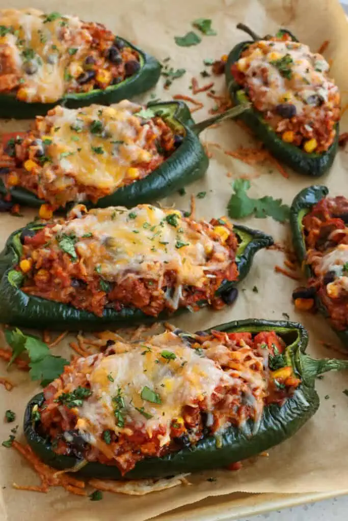 These flavor packed and easy stuffed Poblano Peppers are loaded with ground beef, onion, garlic, white rice, corn, black beans, fire-roasted tomatoes, and melty Monterey Jack and cheddar cheese.
