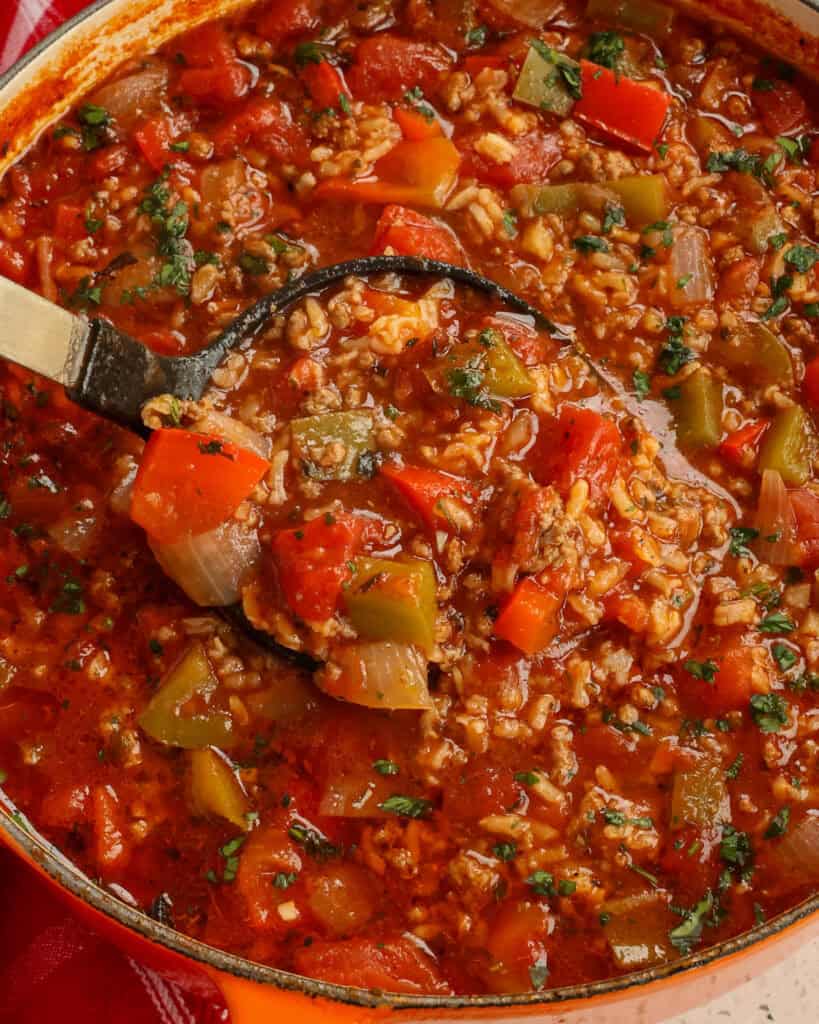 Stuffed Pepper Soup Recipe A Dutch oven and a ladle full of stuffed pepper soup.