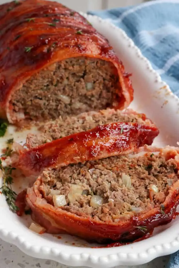 A tender and flavorful Bacon Wrapped Meatloaf recipe with an easy three-ingredient glaze. For the ultimate comfort food meal, serve with southern green beans and mashed potatoes. 