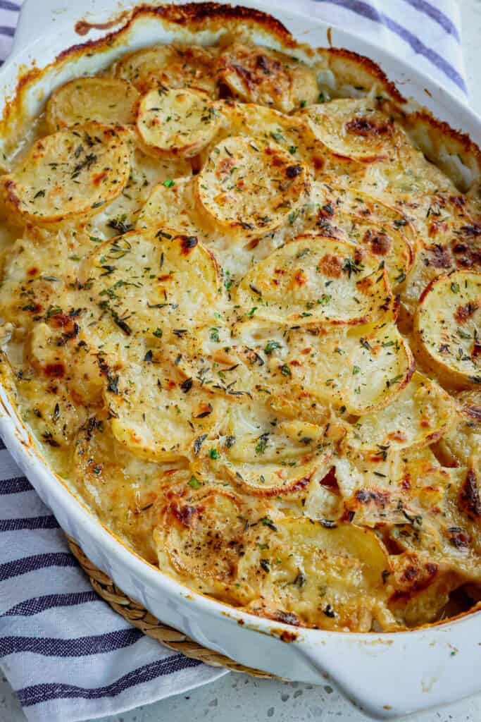 These delicious Classic Scalloped Potatoes are made easily with sautéed onions and garlic, creamy sauce, fresh herbs, and plenty of salt and fresh ground black pepper. 
