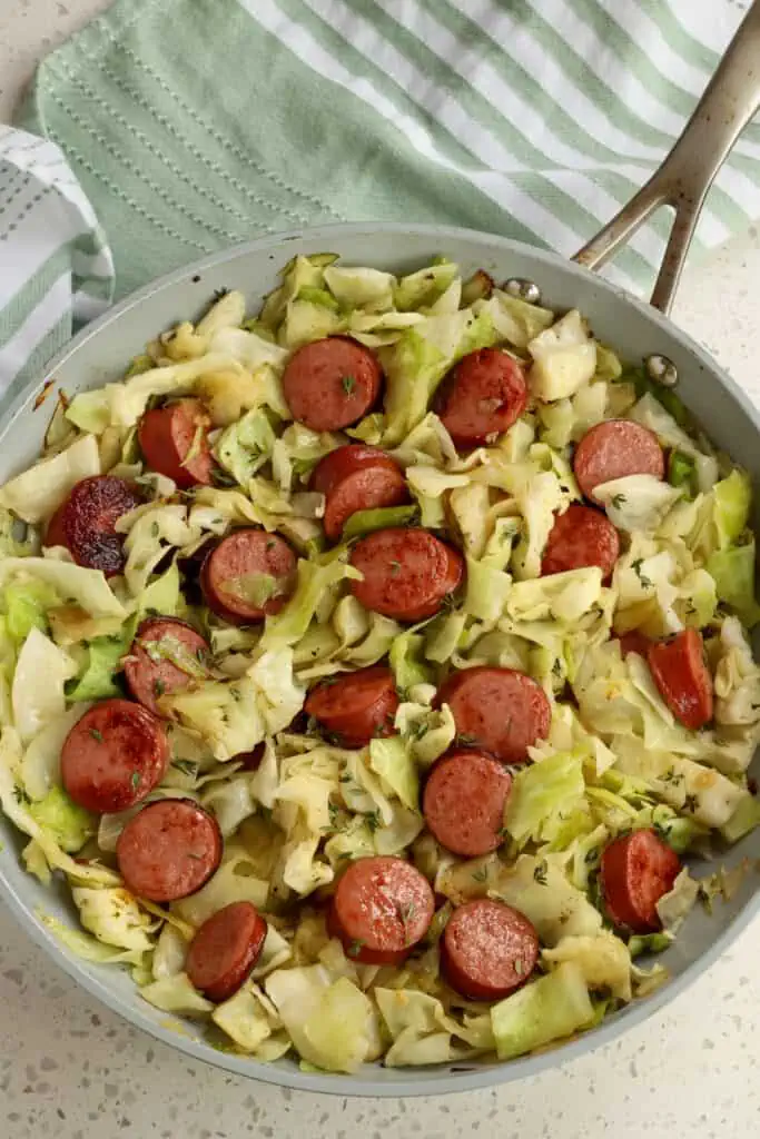 This simple yet delicious Cabbage and Sausage is made in one skillet with simple, low-cost ingredients making it the ideal meal for busy families.