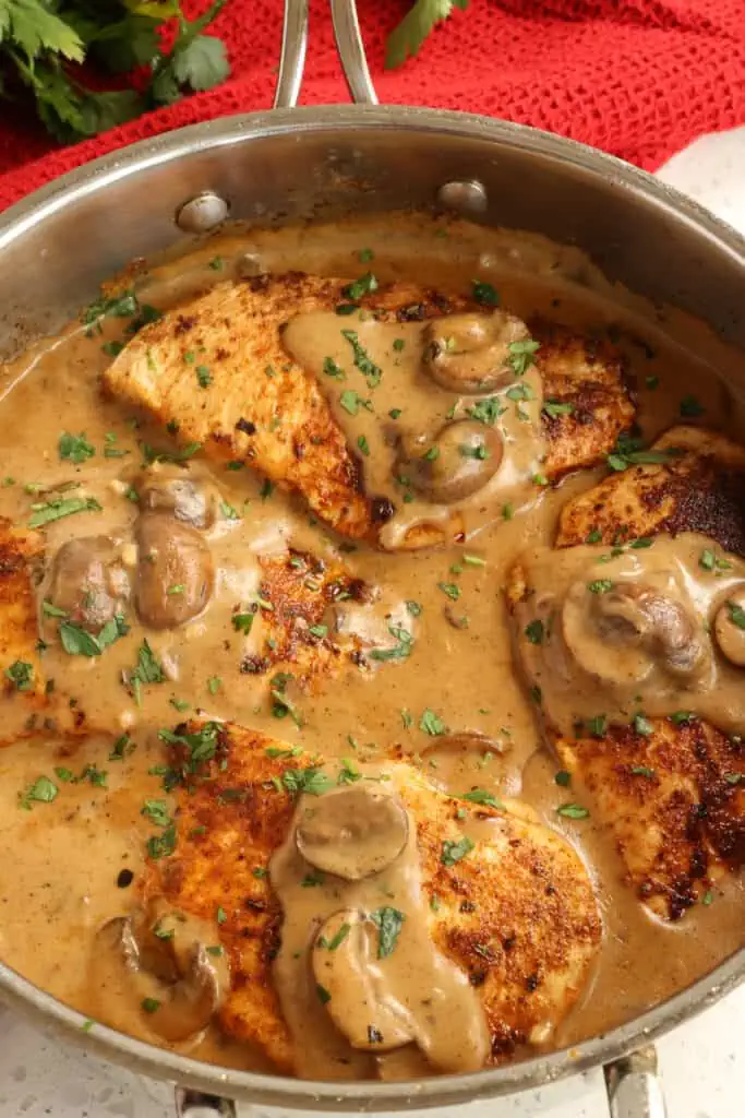 Add the mushrooms, garlic, and chicken back to the skillet and simmer for a couple of minutes to warm. Sprinkle with fresh chopped parsley or thyme. 