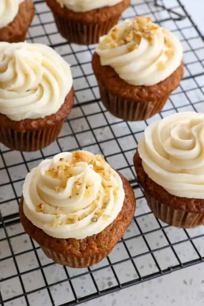 Carrot cupcakes are one of my most requested potluck recipes and are perfect for parties, shindigs, bridal showers, and baby showers.
