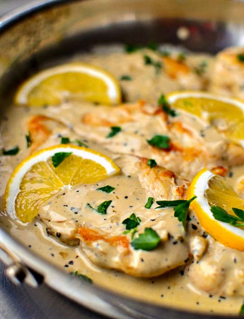 This delicious and simple one skillet chicken recipe combines chicken breasts, garlic and basil in a rich creamy lemon sauce.