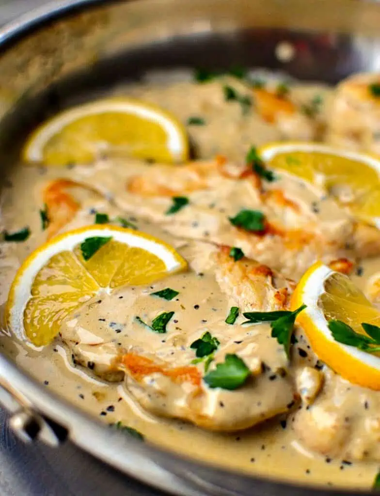 This delicious and simple one skillet chicken recipe combines chicken breasts, garlic and basil in a rich creamy lemon sauce.
