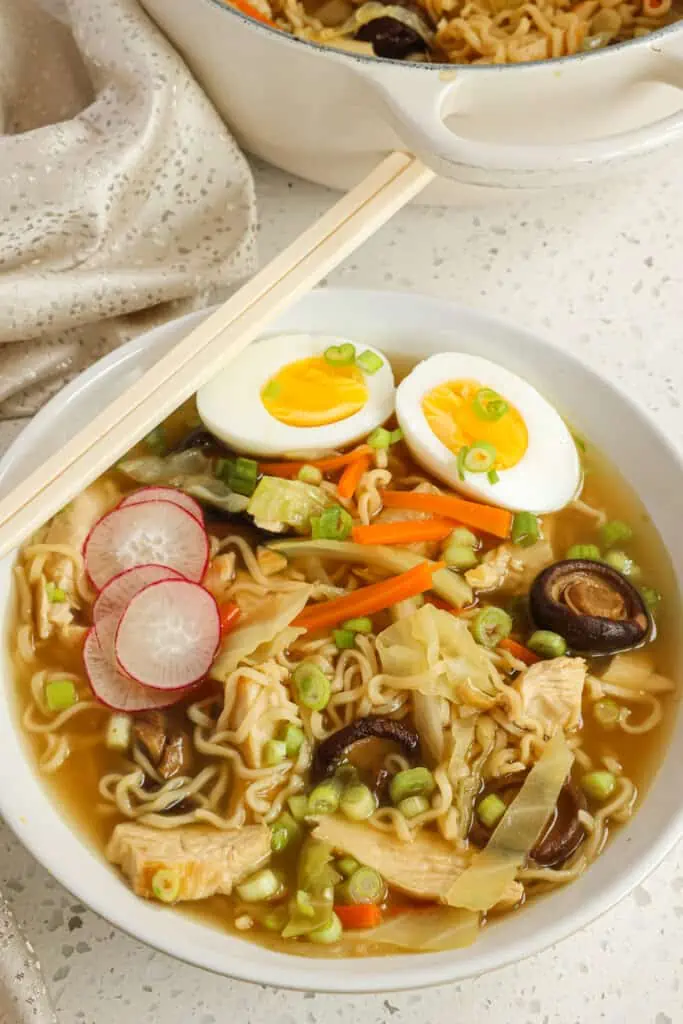 Spoon the soup into bowls and top with green onions, radishes, and 2 egg halves.  