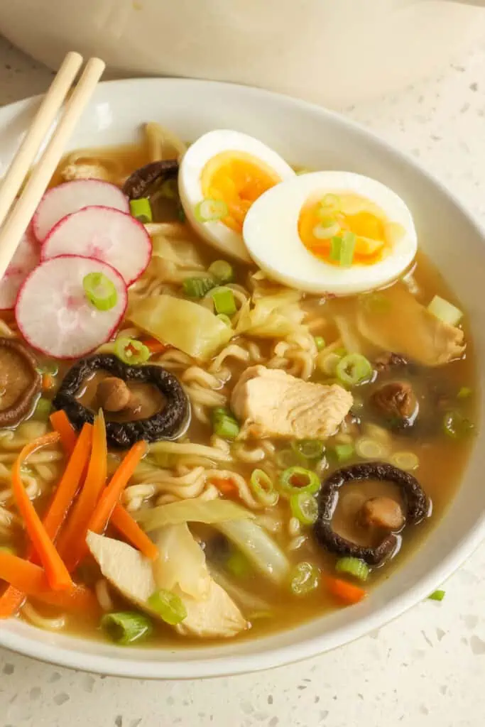 A delicious, simple Chicken Ramen Soup recipe made with pan-seared chicken breasts, ramen noodles, and a variety of veggies, including shiitake mushrooms in a rich broth seasoned with ginger and garlic.
