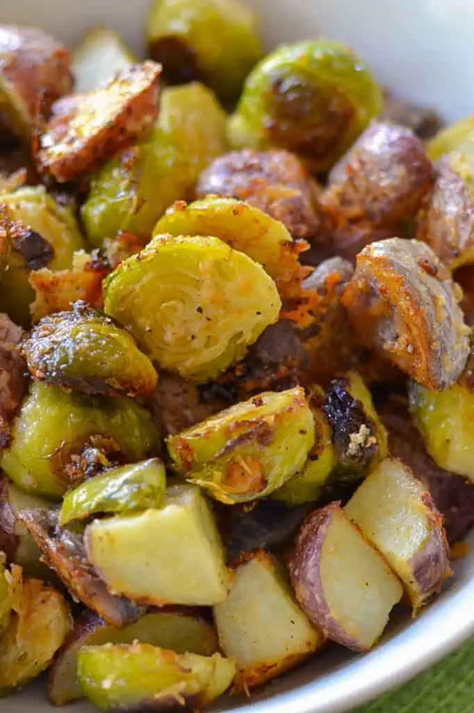 This fabulous lightly seasoned Parmesan Roasted Potatoes and Brussels Sprouts combines both red and purple potatoes with Brussels sprouts and Parmesan.