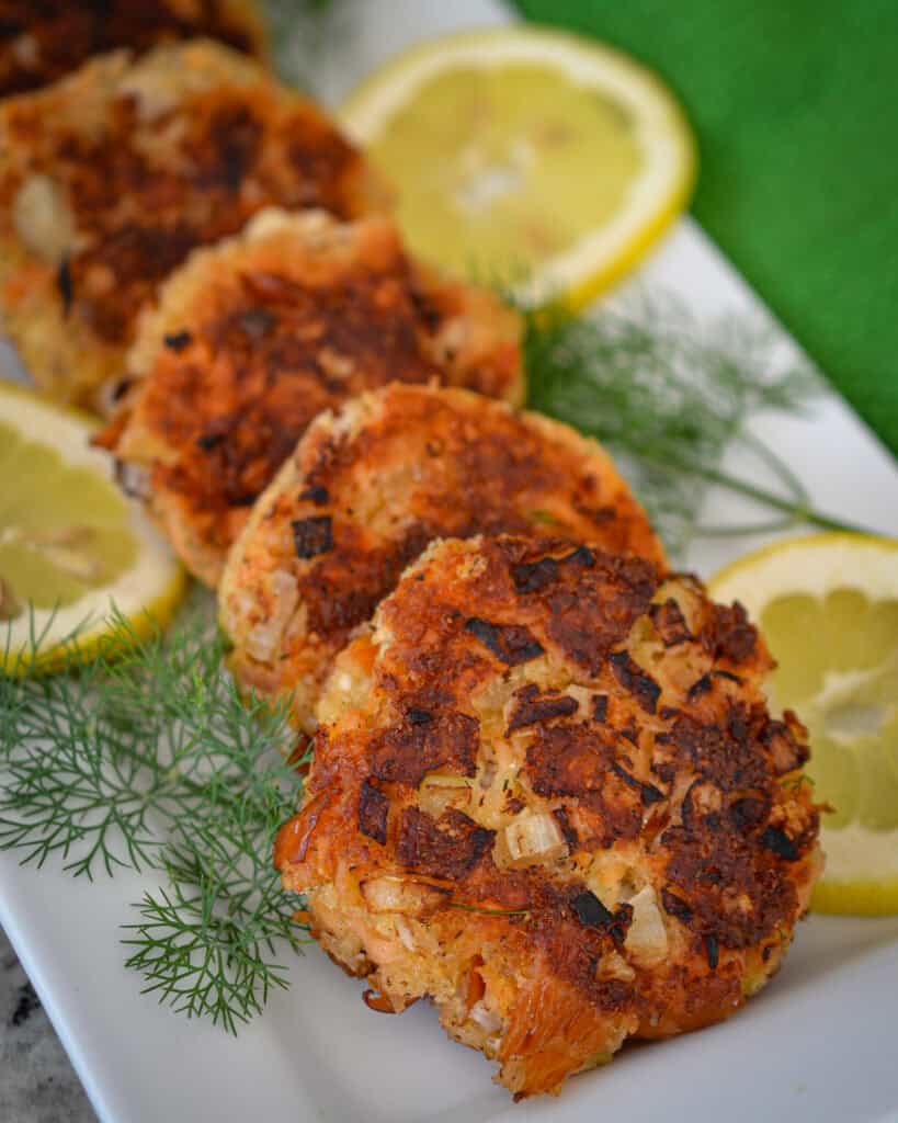 Easy Salmon Patties A close up view of salmon patties on a white platter.