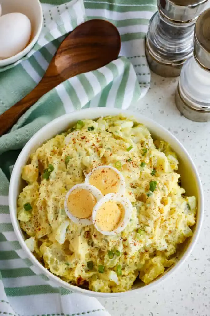 Classic Southern Potato Salad made with sweet pickle relish, hard-boiled eggs, celery, and green onions in a creamy mayonnaise and mustard dressing. Guaranteed to be a hit at your next gathering.