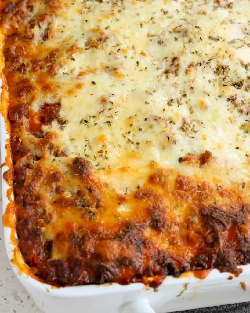 Scrumptious spaghetti casserole covered in a blanket of mozzarella and provolone. 