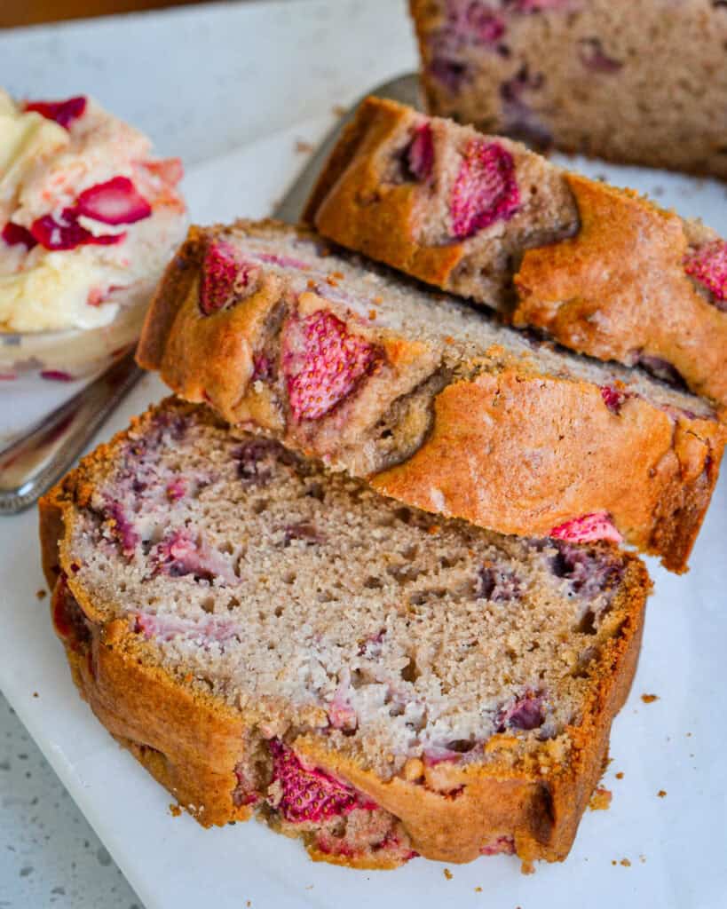 Strawberry Butter Three slices of strawberry bread with a small dish of strawberry butter on the side.