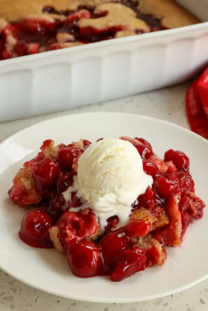 Easy upside down Cherry cobbler is ready for the oven in less than 10 minutes using common pantry ingredients and a can of premium cherry pie filling. Enjoy with fresh whipped cream or with real vanilla ice cream.