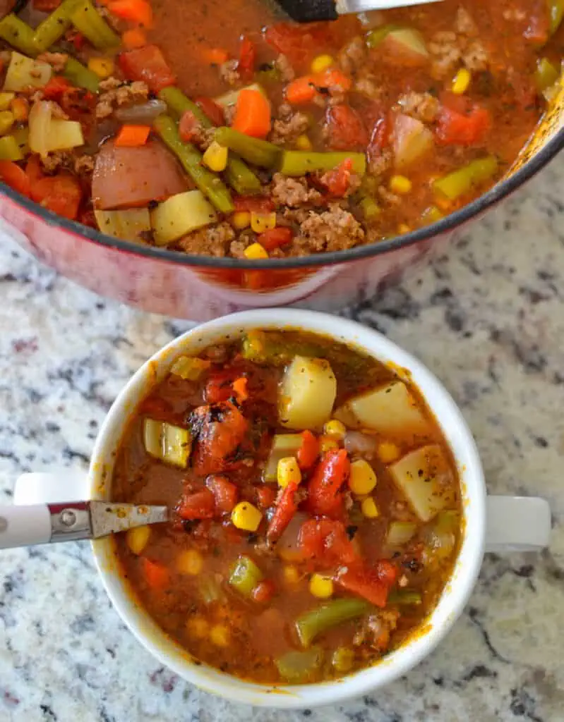 This delicious hamburger soup brings ground beef, onions, celery, carrots, green beans, tomatoes, corn, potatoes, and a perfect blend of spices together in a seasoned vegetable stock. 