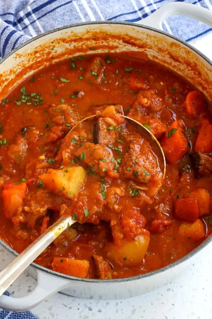 Hungarian Goulash is a slow-cooked tender beef stew (or soup) traditionally made with onions, potatoes, carrots, tomatoes, and sometimes bell peppers, all seasoned with sweet paprika, and caraway seeds. 