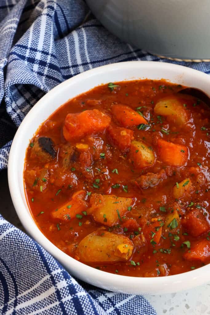 An authentic Hungarian Goulash recipe with tender beef, onions, carrots, and potatoes, all cooked up in a beef tomato base seasoned with bay leaves, paprika, and caraway seeds.