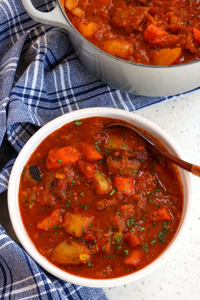 Authentic Hungarian Goulash, or as the Hungarians call it Gulyás, combines tender chunks of beef with onions, tomatoes, carrots, and potatoes in a rich tomato beef broth seasoned with Hungarian sweet paprika and caraway seeds.