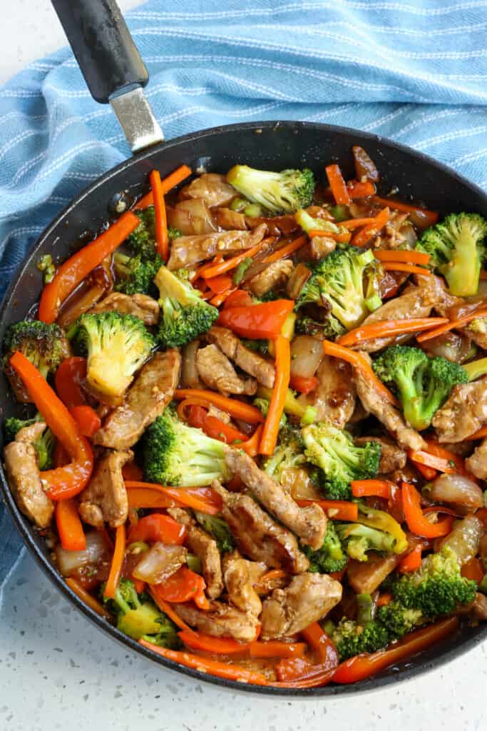 This Pork Stir Fry is full of flavor from garlic, ginger, sesame, and honey and loaded with tasty vegetables like onion, broccoli, red bell pepper, and carrots.