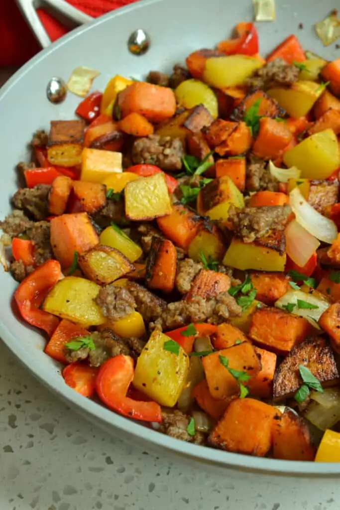 This hearty Sweet Potato hash has sweet and savory flavors with sweet potatoes and gold potatoes, onions, sweet bell peppers, and ground pork sausage.