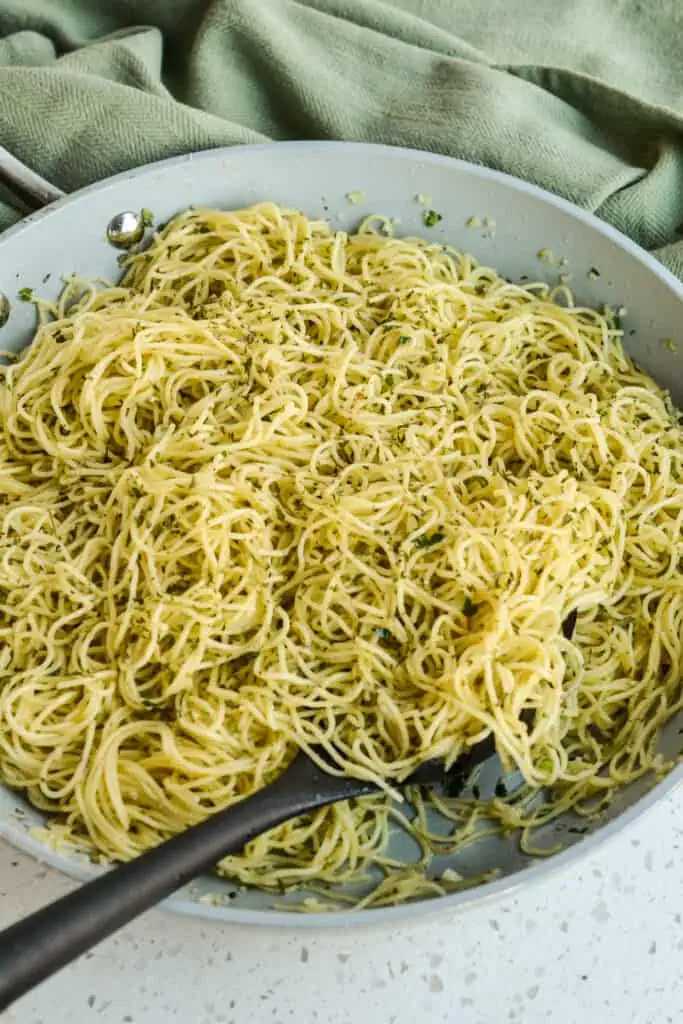 A tasty Angel Hair Pasta Recipe with fresh garlic, herbs, and Parmesan Cheese that pairs well with almost any main course. 