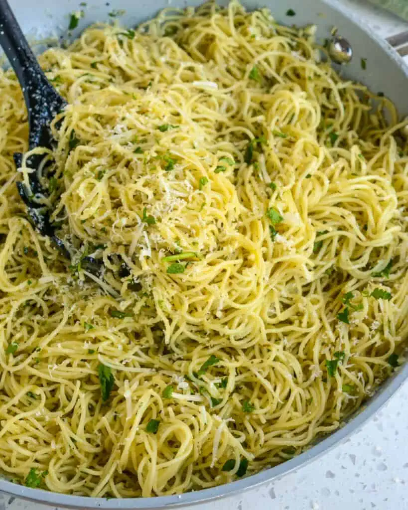 A quick and easy Angel Hair Pasta recipe with fresh garlic, herbs, and grated Parmesan Cheese. 