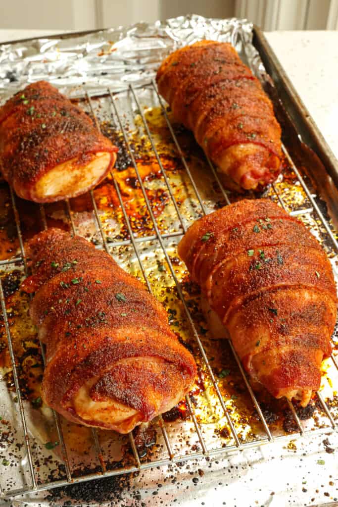 These amazing bacon-wrapped chicken breasts are sprinkled with a brown sugar and paprika dry rub, then wrapped in bacon, sprinkled again with the rub, and baked to golden brown perfection. 