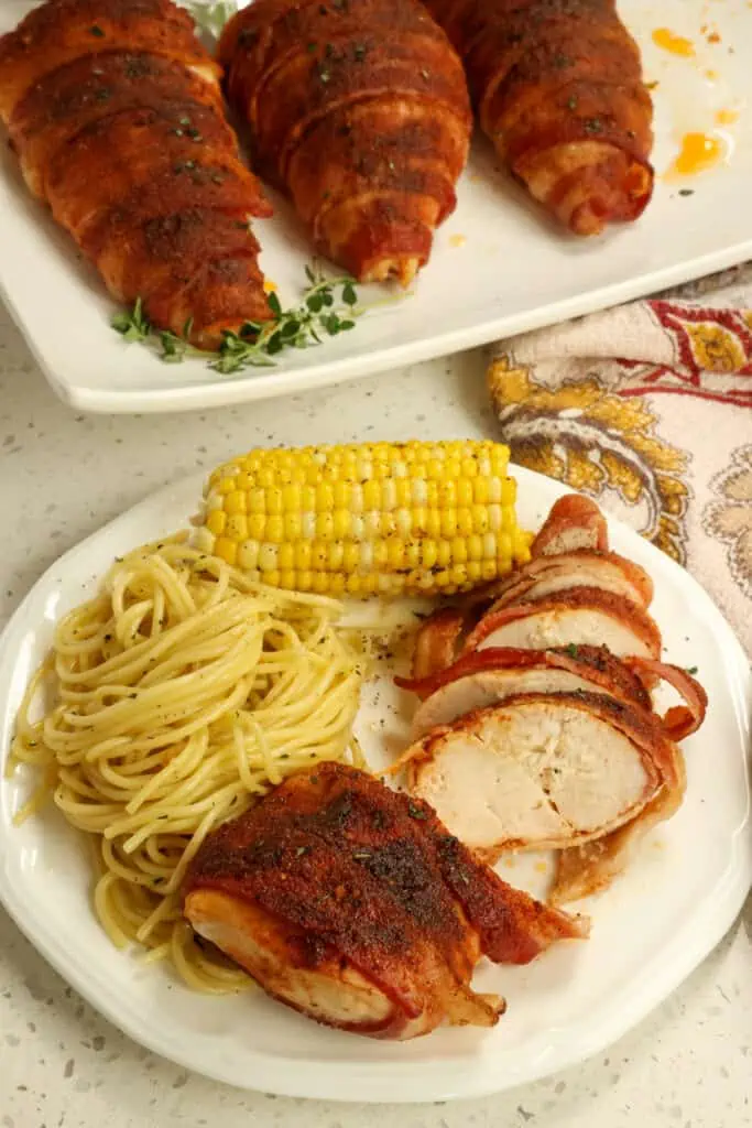 Brown sugar and paprika dry-rubbed seasoned chicken breasts are wrapped in bacon and baked to golden perfection. 