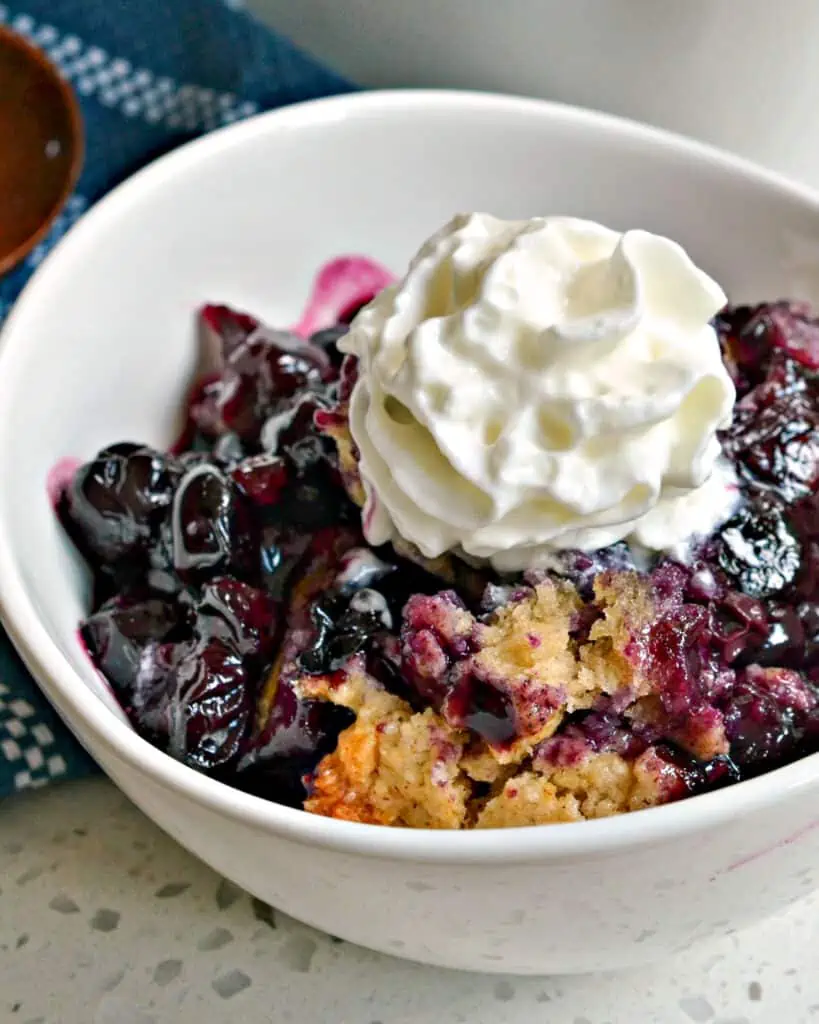 This southern Blueberry Cobbler has an eight ingredient flaky biscuit topping that is sprinkled lightly with sugar.  