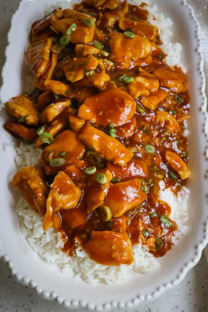 This delicious and easy Bourbon Chicken recipe combines golden browned chicken breast bites with sweet sticky bourbon sauce with a hint of spice. 