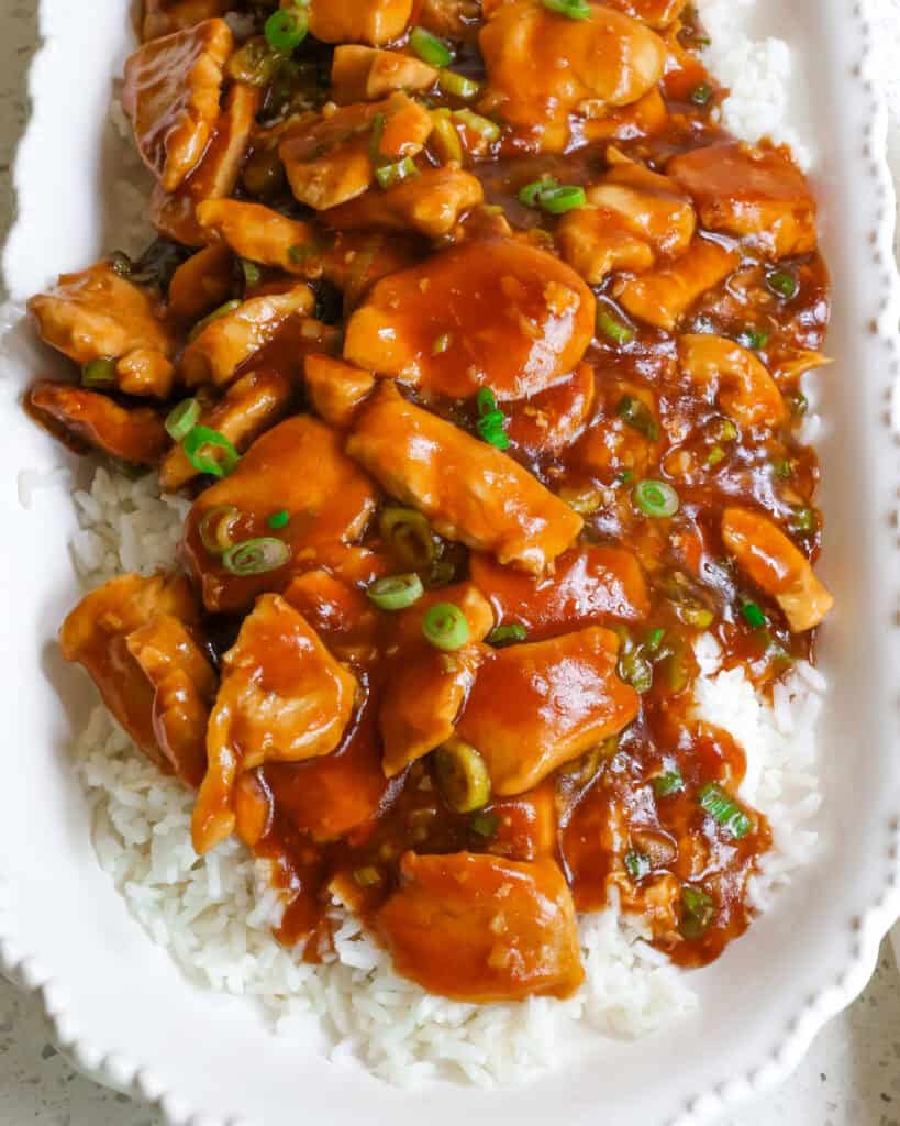 Bourbon Chicken Recipe Bourbon chicken over rice on a serving platter.