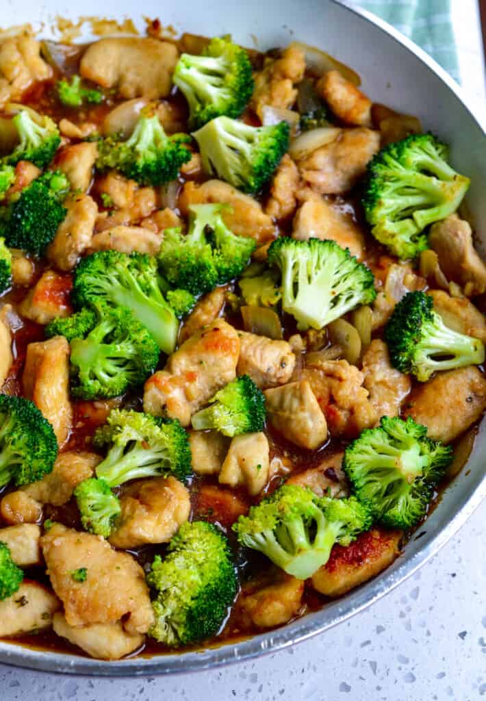 This easy Chicken and Broccoli Stir Fry Recipe combines crisp stir-fried golden chicken breast pieces with broccoli and onions in an easy, slightly sweet, and spicy ginger honey stir fry sauce for an authentic Chinese stir fry flavor that is so much better than takeout.