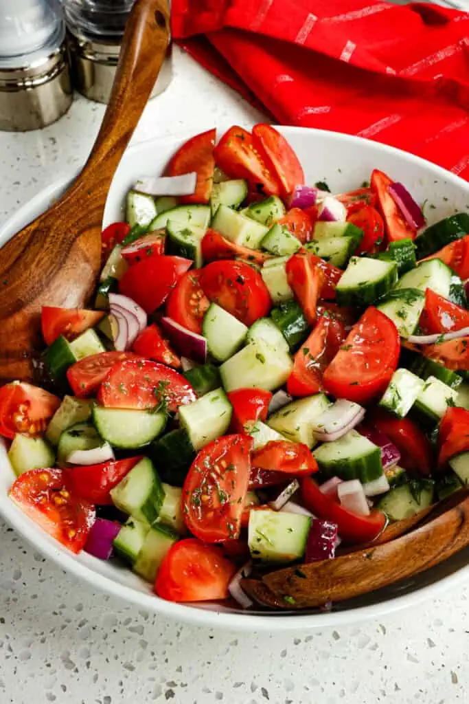 This quick and easy Cucumber Tomato Salad is bursting with flavor from fresh herbs and a tasty four-ingredient vinaigrette.