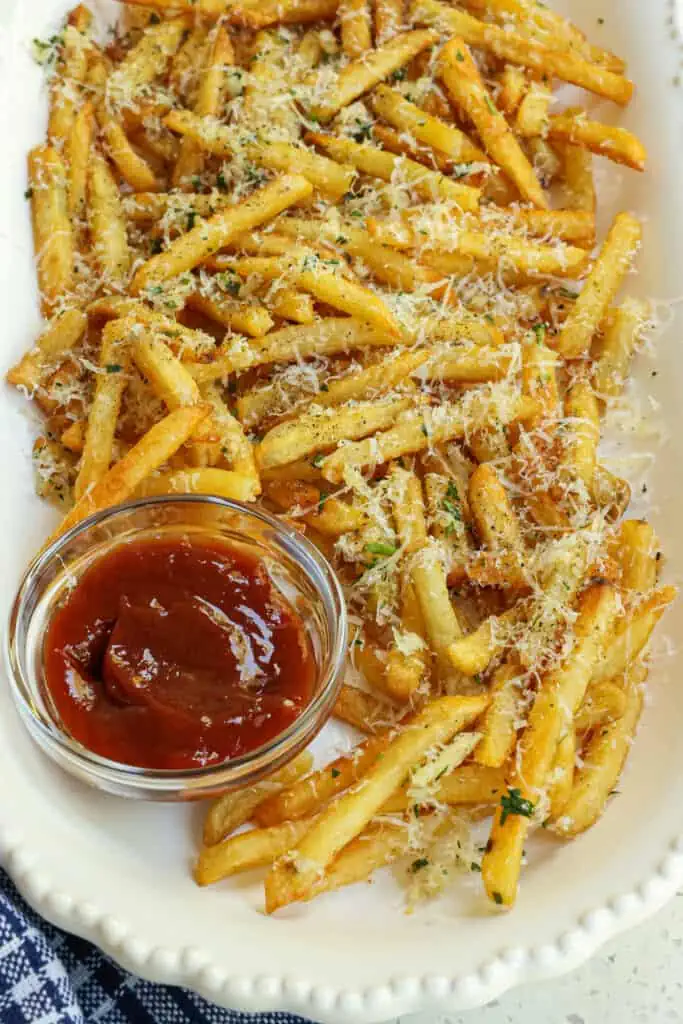 Easy Garlic Parmesan Fries are so tasty with fresh minced garlic, sweet cream butter, and salty fresh Parmesan cheese.