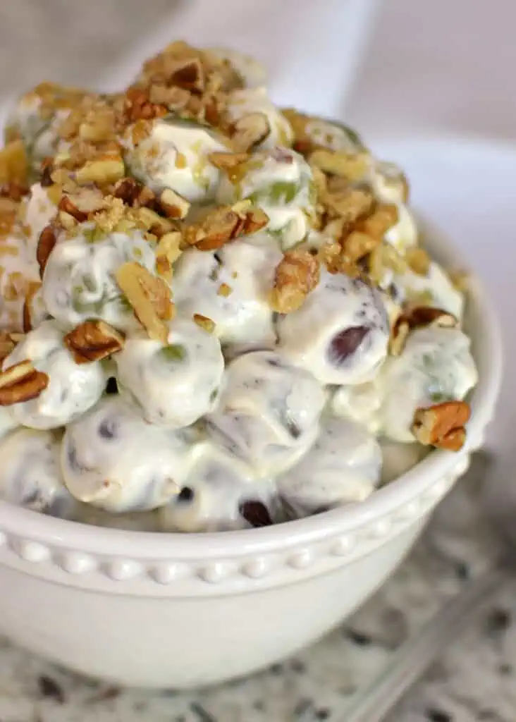 Creamy Grape Salad is a delectable combination of both red and green seedless grapes. cream cheese, sour cream, pecan, walnuts and brown sugar.
