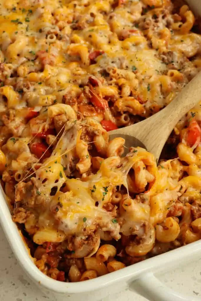 This easy Hamburger Casserole is loaded with sweet onions, red bell pepper, garlic, tomatoes, and elbow macaroni, all in a perfectly seasoned tomato sauce base and topped with Monterey Jack cheese and cheddar cheese. 
