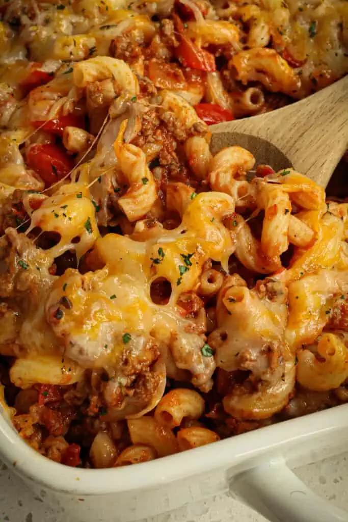 Quick and easy Hamburger Casserole with onions, bell peppers, garlic, tomatoes, elbow macaroni, and diced tomatoes, all under a blanket of melty Monterey Jack and cheddar cheese.