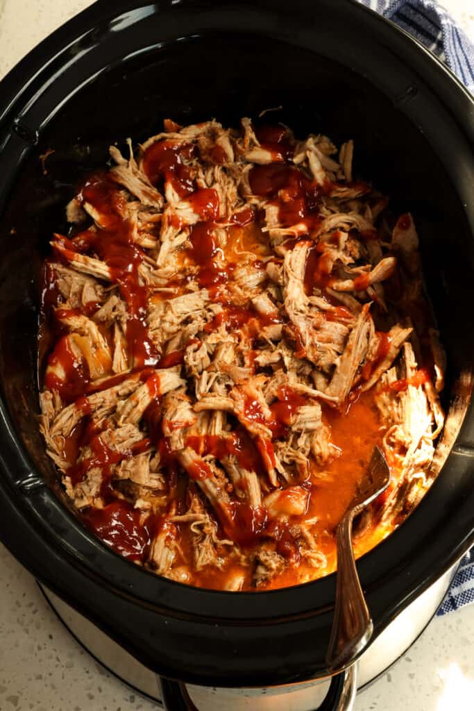 Drizzle the homemade barbecue sauce over pulled pork.
