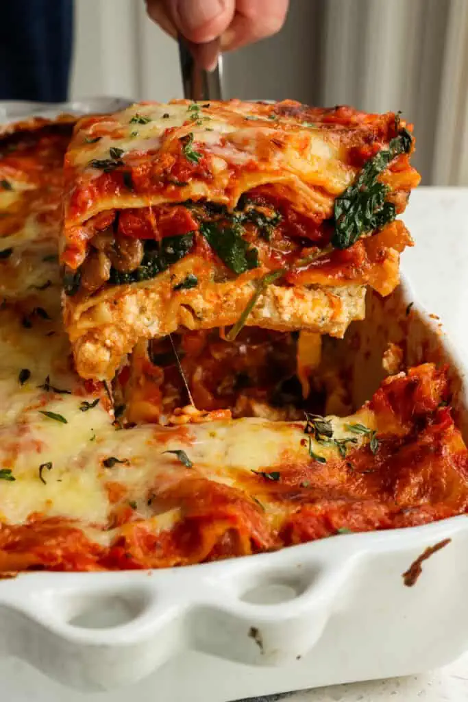 A tasty three-layer cheesy vegetable lasagna layered with ricotta cheese, sautéed veggies, mozzarella, and marinara sauce. 