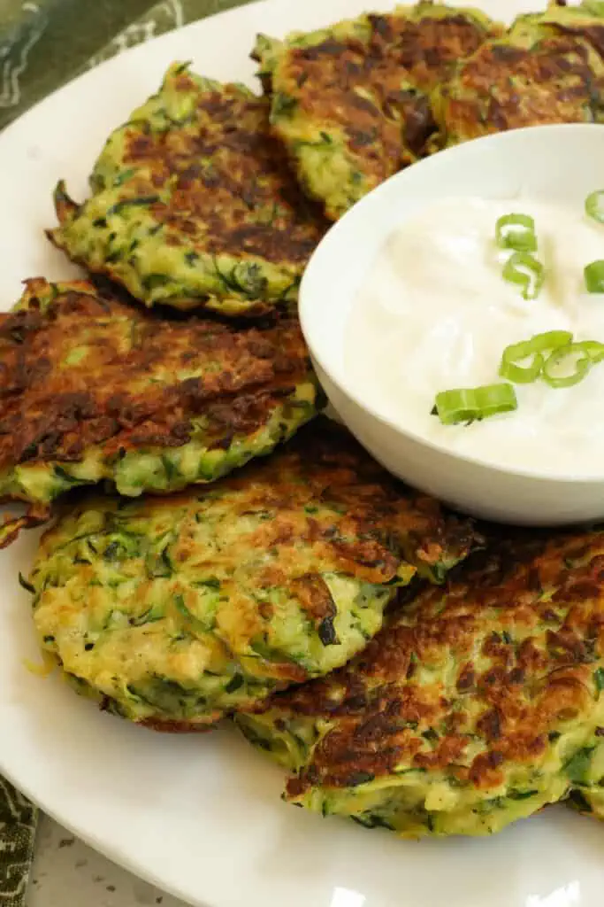 Serve zucchini fritters right out of the skillet with sour cream or warm marinara. 