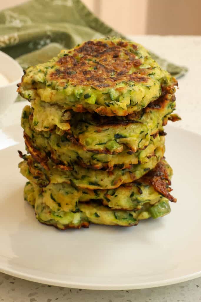 Easy Zucchini Fritters are crispy on the outside and tender on the inside with plenty of flavor from Parmesan Cheese, green onions, and fresh herbs.