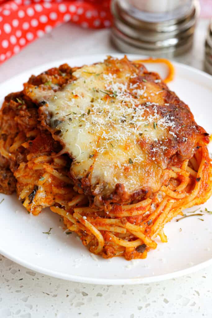A hearty Spaghetti Casserole filled with ground beef, onions, garlic, and sauce with cream cheese, ricotta, sour cream, and mozzarella mixture layered in the middle.  This scrumptious dish is always a hit with family and friends.