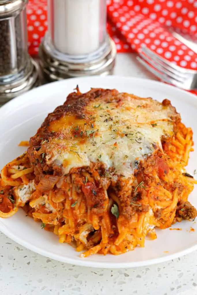 Baked Spaghetti Casserole, also known as Million Dollar Spaghetti Casserole combines ground beef, spaghetti, and spaghetti sauce with a mixture of cream cheese, ricotta cheese, and sour cream baked into the center. 