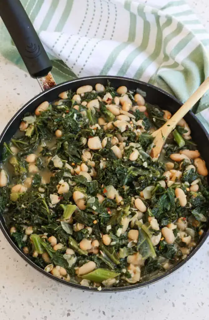 Quick and Easy Beans and Greens combine onions, garlic, kale, and cannellini beans in perfectly seasoned chicken broth.