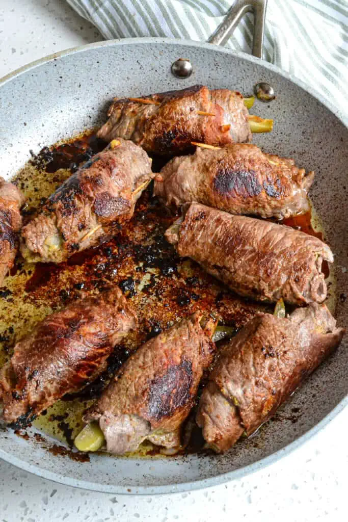 Now heat a little vegetable oil and butter in a large ovenproof skillet or Dutch oven over medium-high heat.  Brown the beef rolls on all sides.