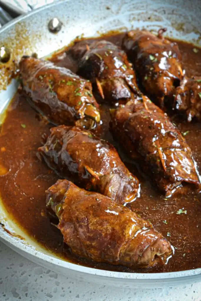 German Beef Rouladen are rolls of thin tender round steak stuffed with spicy mustard, bacon, onions, and pickles all baked to fork tenderness.  Then it is smothered with an easy to make beef sauce made from the delicious browned bits and beef juices.