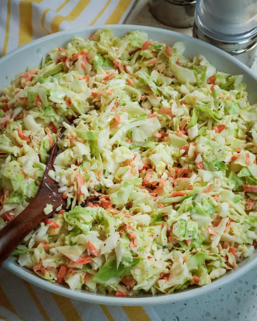 A serving bowl full of coleslaw dressing. 