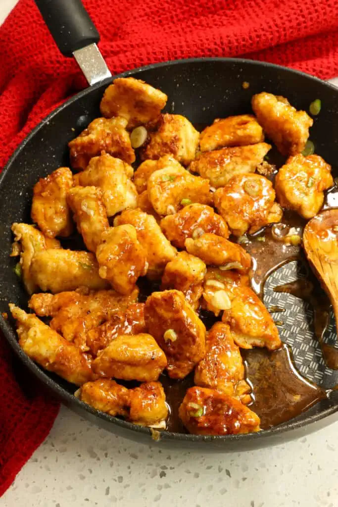 Honey Garlic Chicken combines crispy Asian-style fried chicken pieces and green onions tossed in a quick and easy honey garlic sauce.
