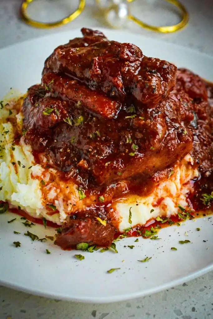 This Swiss Steak Recipe combines melt in your mouth tenderized round steak braised with onions, carrots, garlic, and tomatoes.  For a complete meal serve over creamy mashed potatoes, white rice, or Amish egg noodles.  