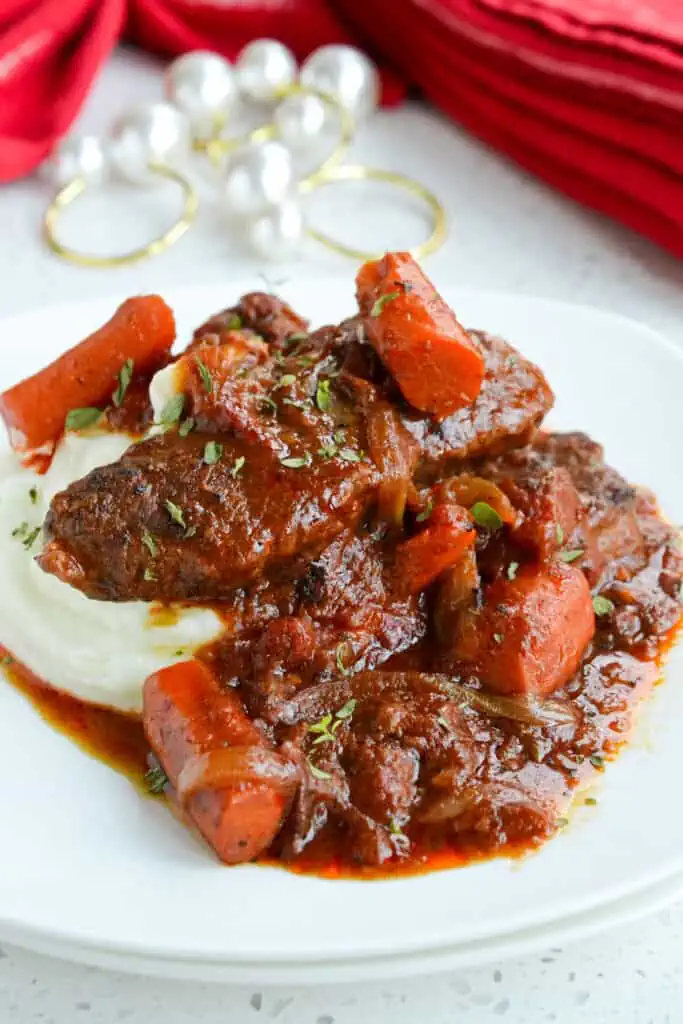 This AMAZING Swiss Steak recipe is pure comfort food at its best flavor.  Beef round steak is tenderized, browned, and slow-cooked to perfection with onions, garlic, and carrots in a lightly seasoned tomato sauce. 