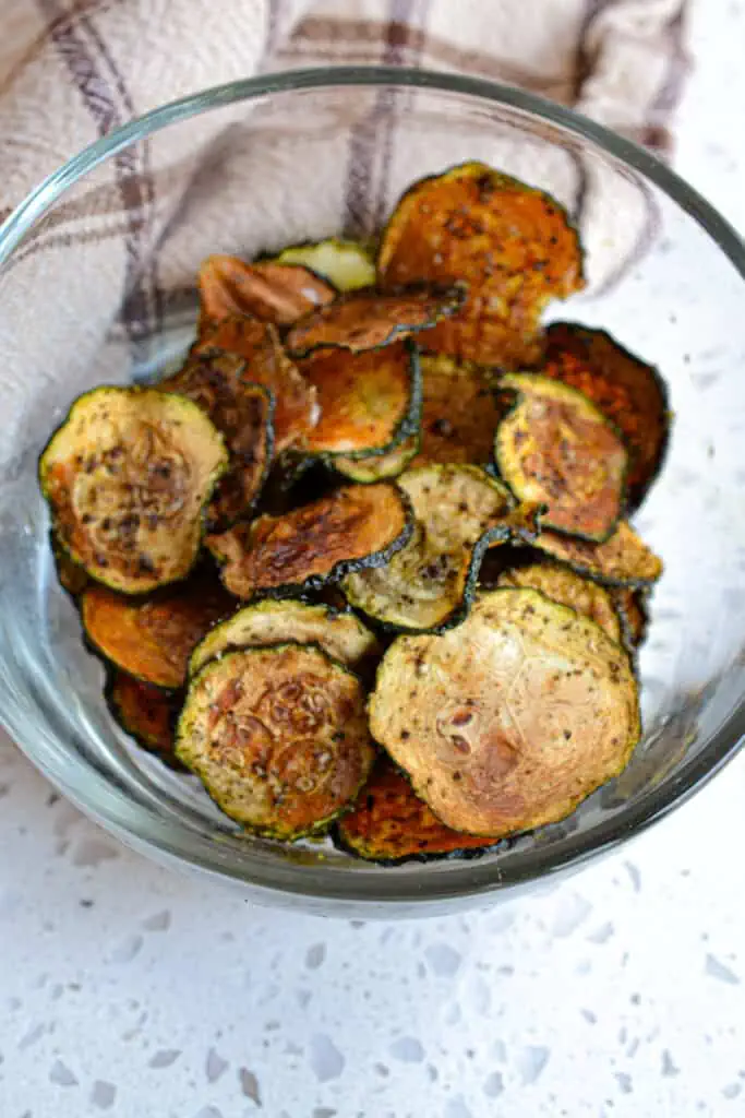These fun zucchini vegetable chips are crisp, tasty, and easy to make. They require time and patience as they cook low and slow for a couple of hours.